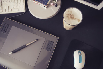 Empty workspace of a designer with graphic tablet and pen, keybo