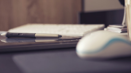 Empty workspace of a designer with graphic tablet and pen, keybo