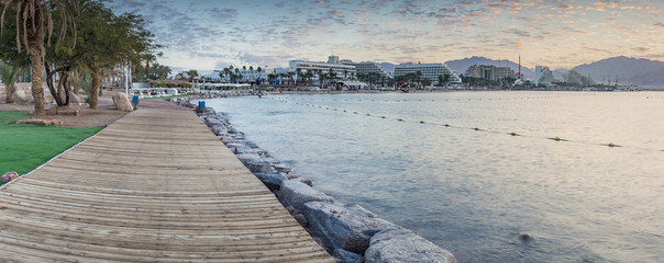 Fototapeta premium Panoramic view on the central public beach with resort hotels in Eilat - famous resort city in Israel. Photos were taken at dawn