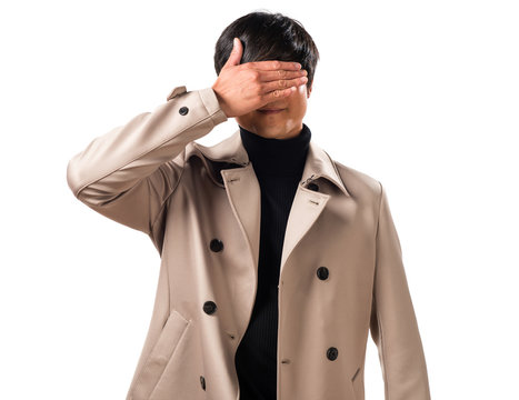 Asian handsome man covering his eyes
