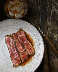 Sliced medium rare grilled Beef steak Ribeye on a plate