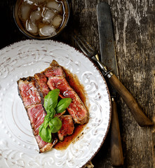 Sliced medium rare grilled Beef steak Ribeye on a plate