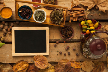 Ingredient for preparing healthy tea with spices and carnation, free space on blackboard, you can place your recipe.
