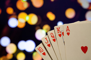 Royal flush poker cards combination on blurred background casino luck fortune