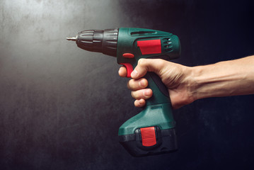 male hand holding a screwdriver, for screwing screws
