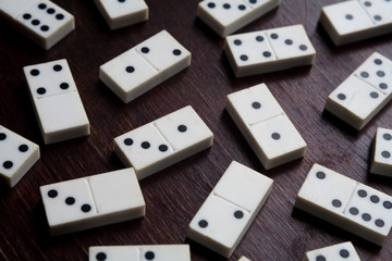 domino pieces on the brown wooden table background games luck fortune