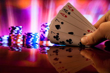 Hand holding full house poker cards combination on blurred background casino luck fortune - obrazy, fototapety, plakaty