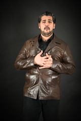 Handsome man doing different expressions in different sets of clothes: heart attack