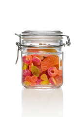 Jar filled with brightly coloured sweets (fruity jelly sweets).
