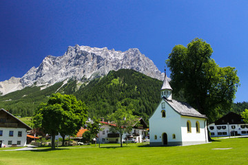 Fototapeta na wymiar church in Ehrwald village Austria view of near border of Germany highest mountain Zugspitze Alps