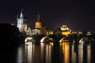 Charles Bridge old city of Czech Republic capital Prague at night reflection of lights in river