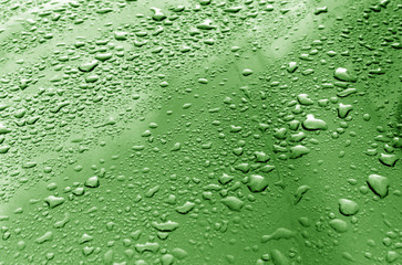 Rain drops on green metal surface.