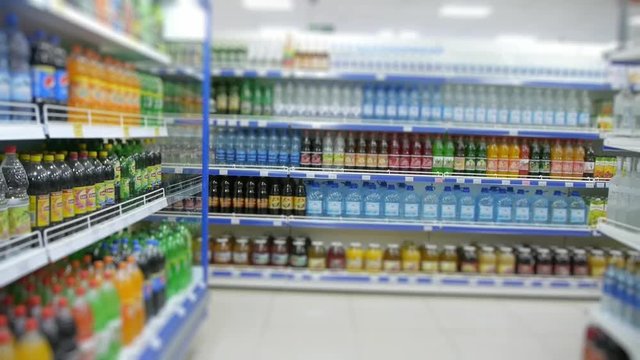 shelf of sodas in the supermarket, blurred