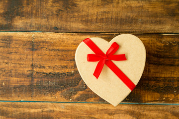 Beautiful gift with heart shape and red ribbon
