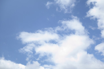 the white clouds floating on a background of blue sky