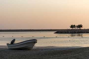 Naklejka premium Boat on the beach in salalah oman sunrise time 2
