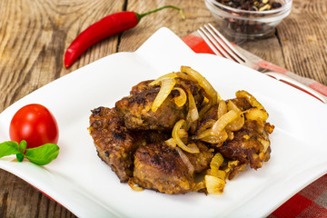 Fried beef liver with onions, curry and spices
