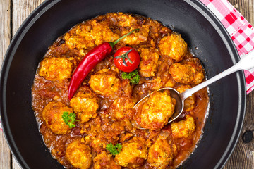 Chicken meatballs with vegetable spicy sauce in the pan