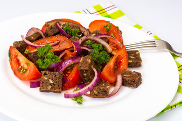 Simple salad with bread, tomato, red onion, vegetable oi