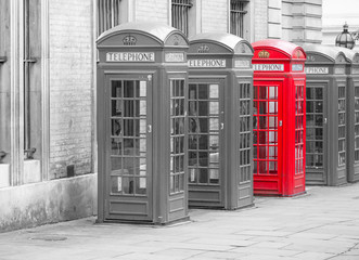 Fototapeta premium Five Red London Telephone boxes landscape in black and white with one red one