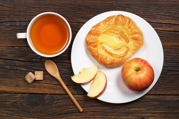 Tea and bun with apple