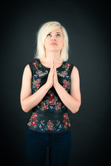Beautiful woman doing different expressions in different sets of clothes: prayer