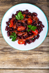 Salad with cherry tomatoes and red beans in spicy tomato sauce