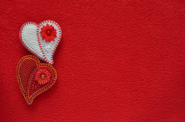 Two beaded jewelry on a red background fleece