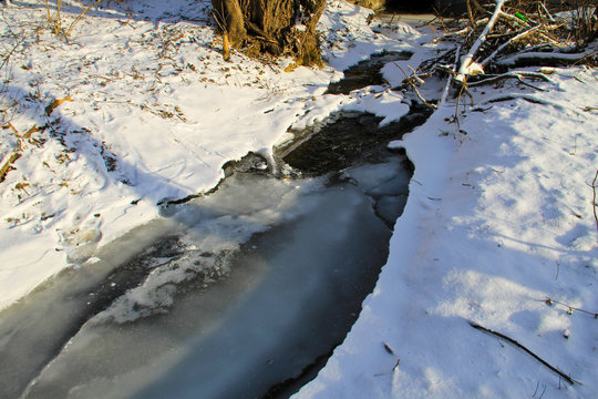 Small stream in the snowy forest