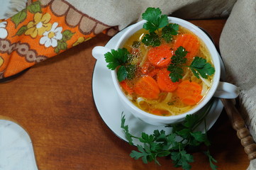 Hot traditional chicken soup in a white dish - energy and warming meal on a cold day
