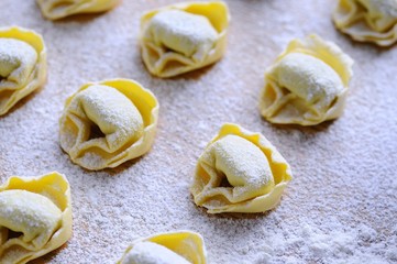 Preparing homemade tortellini.