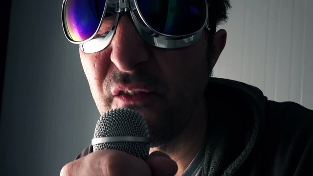 Alternative rock music singer singing song into microphone, strobe light effect