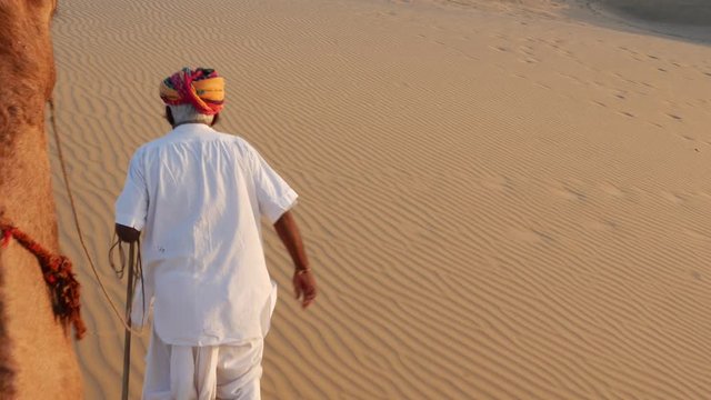 Point of View of a ride of camel in sand dunes in the desert