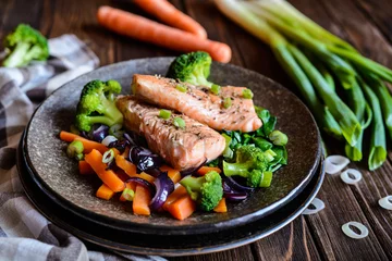 Foto op Plexiglas Gebakken zalmsteaks met gestoomde wortel, broccoli, ui en spinazie © noirchocolate