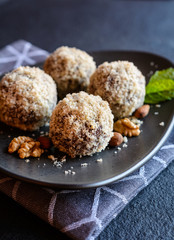 Unbaked sweet balls made of walnut, cocoa and almond