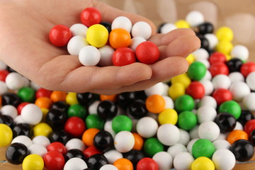 colourful bonbons in a child's hand
