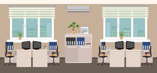 Office room interior including four work spaces with cityscape outside window.