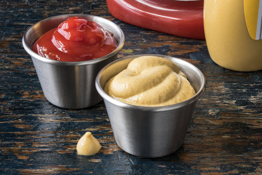 Ketchup and mustard in stainless cups