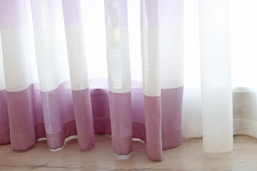 Room window with white and lilac curtains, close up