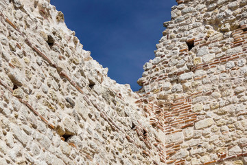 Fortress wall against the blue sky .