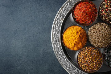 Different spices in bowls on plate