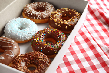 Tasty donuts in paper box, closeup