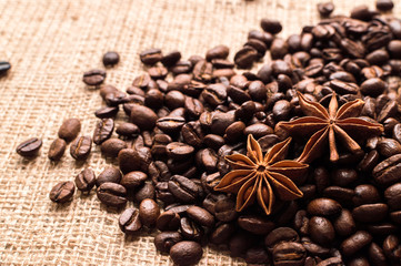Coffee beans and badian on the sackcloth background