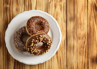 Tasty donuts on wooden background
