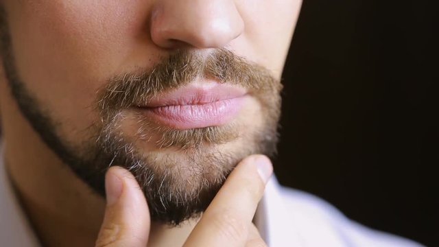 The man's smile.A man with a beard smiling. Close-up. sexy lips