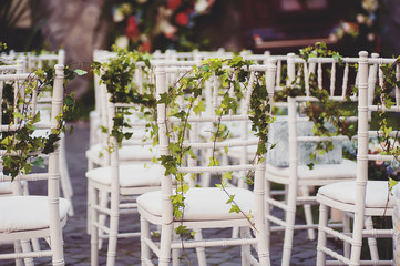 white chairs decorated with flowers.wedding concept.