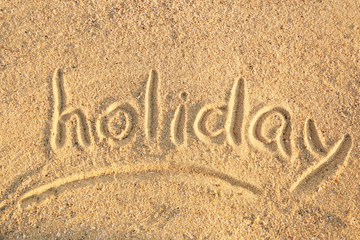 Handwritten inscription on sea sand, close up view