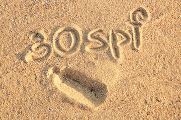 Handwritten inscription on sea sand, close up view