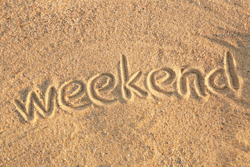 Handwritten inscription on sea sand, close up view