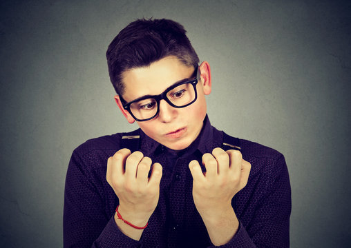 man looking at hands nails obsessing about cleanliness germs